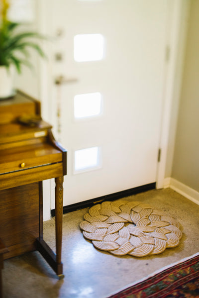 Handmade jute boho rug on floor next to door